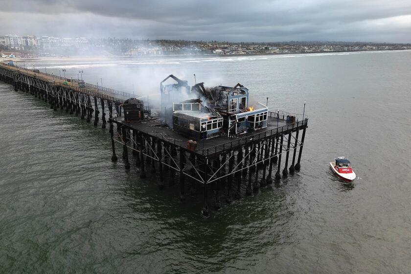 Oceanside, CA_4_26_24_The Oceanside Pier continues to burn Friday morning after a fire which started at the end of the pier burned the former Ruby's Diner and The Brine Box. Photo by John Gastaldo for the Union-Tribune