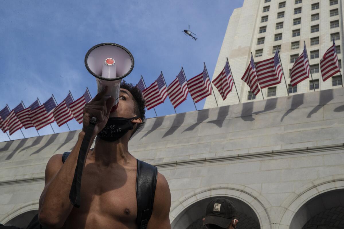 Marcus Owen, with bullhorn, outside Los Angeles City Hall