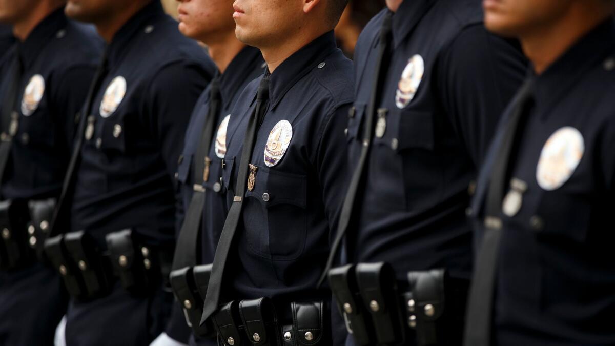 New Los Angeles police officers stand at attention during a graduation ceremony last year.
