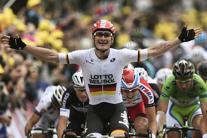 Andre Greipel of Germany celebrates as he crosses the finish line of the sixth stage of the Tour de France, a 194-kilometer ride from Arras to Reims in France.