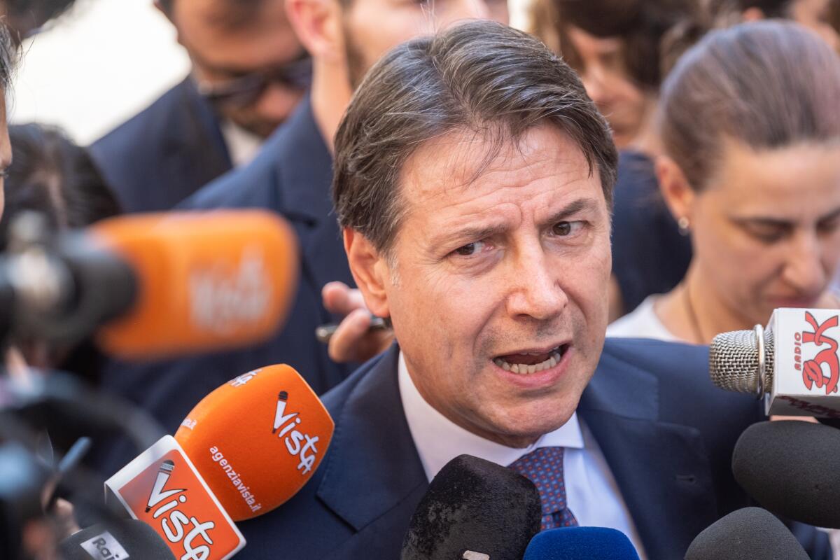 Former Italian Premier and 5-Star Movement Leader Giuseppe Conte talks to journalists outside Chigi Palace government offices in Rome, Wednesday, July 6, 2022, after meeting with Italian premier Mario Draghi. Conte met for more than an hour Wednesday with Premier Mario Draghi, who has made plain that if Conte pulls yank the support of his 5-Star Movement, the pandemic unity government would be finished. (Mauro Scrobogna/Lapresse via AP)