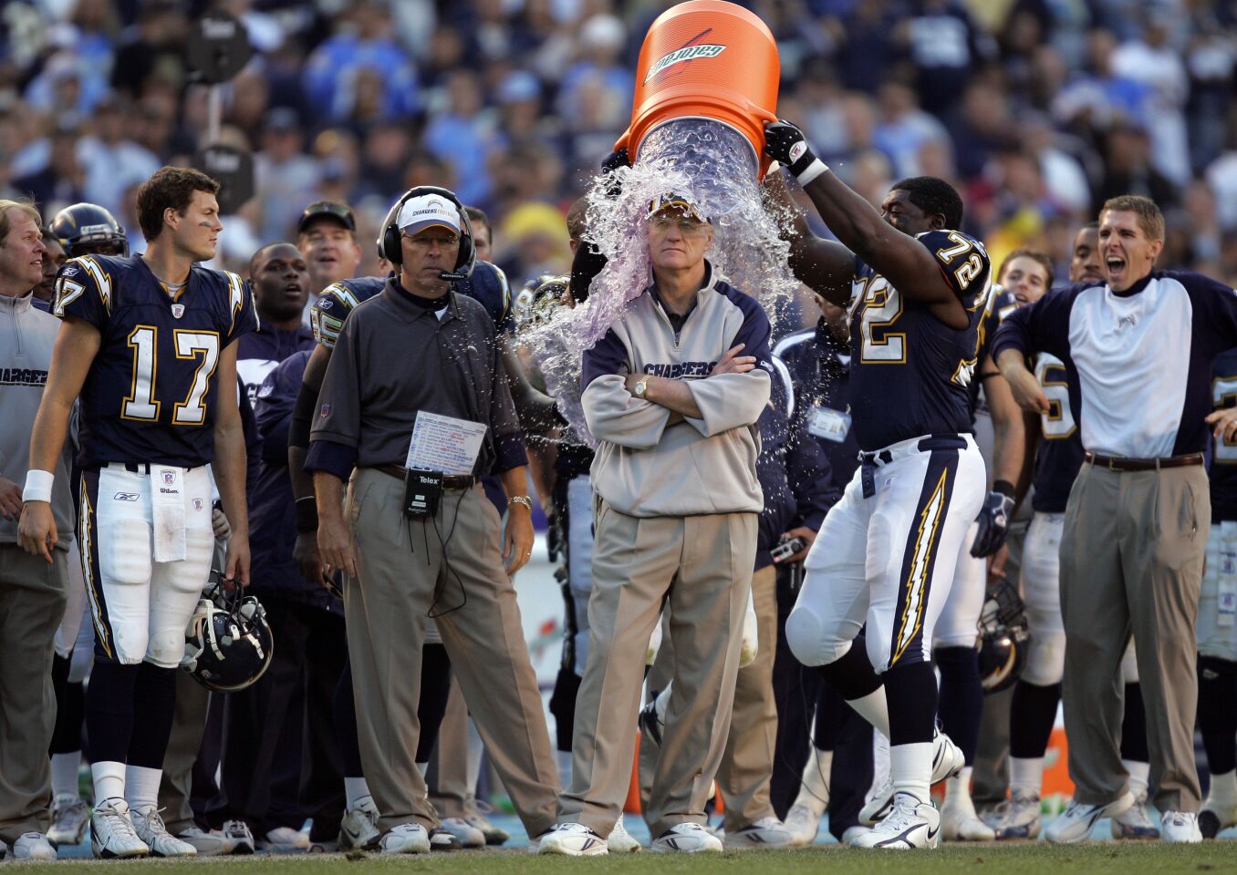 Chargers Philip Rivers, left, looks on as coach Marty Schottenheimer is dunked with water after his 200th NFL win against the Arizona Cardinals on Dec. 31, 2006, at Qualcomm Stadium.