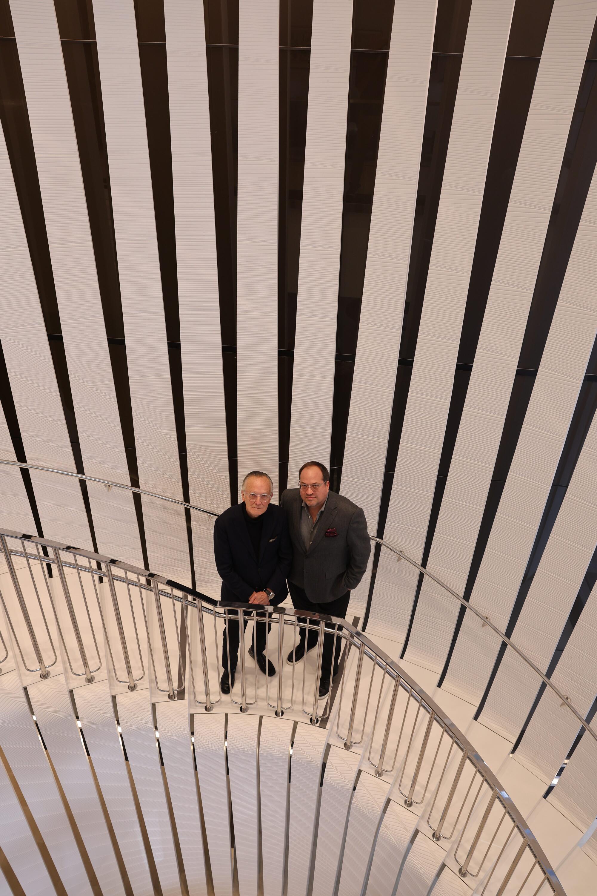 Architect Scott Johnson and developer Stuart Morkun stand in a staircase with lined walls