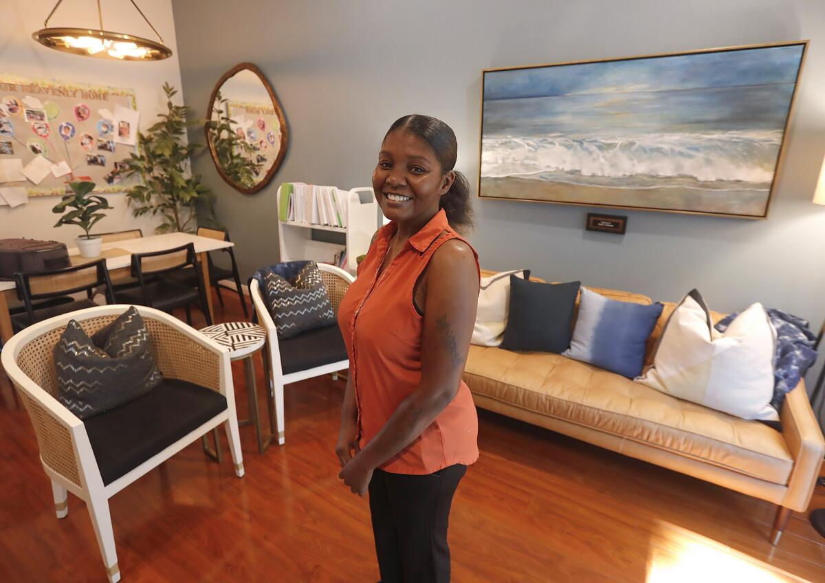 The Heavenly Home manager Ky'Shawna Owensby stands in the living room at the Mission Viejo hospice house.