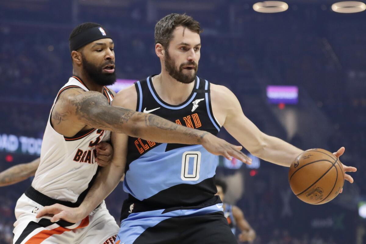 Clippers forward Marcus Morris Sr. tries to steal a pass to Cavaliers forward Kevin Love.