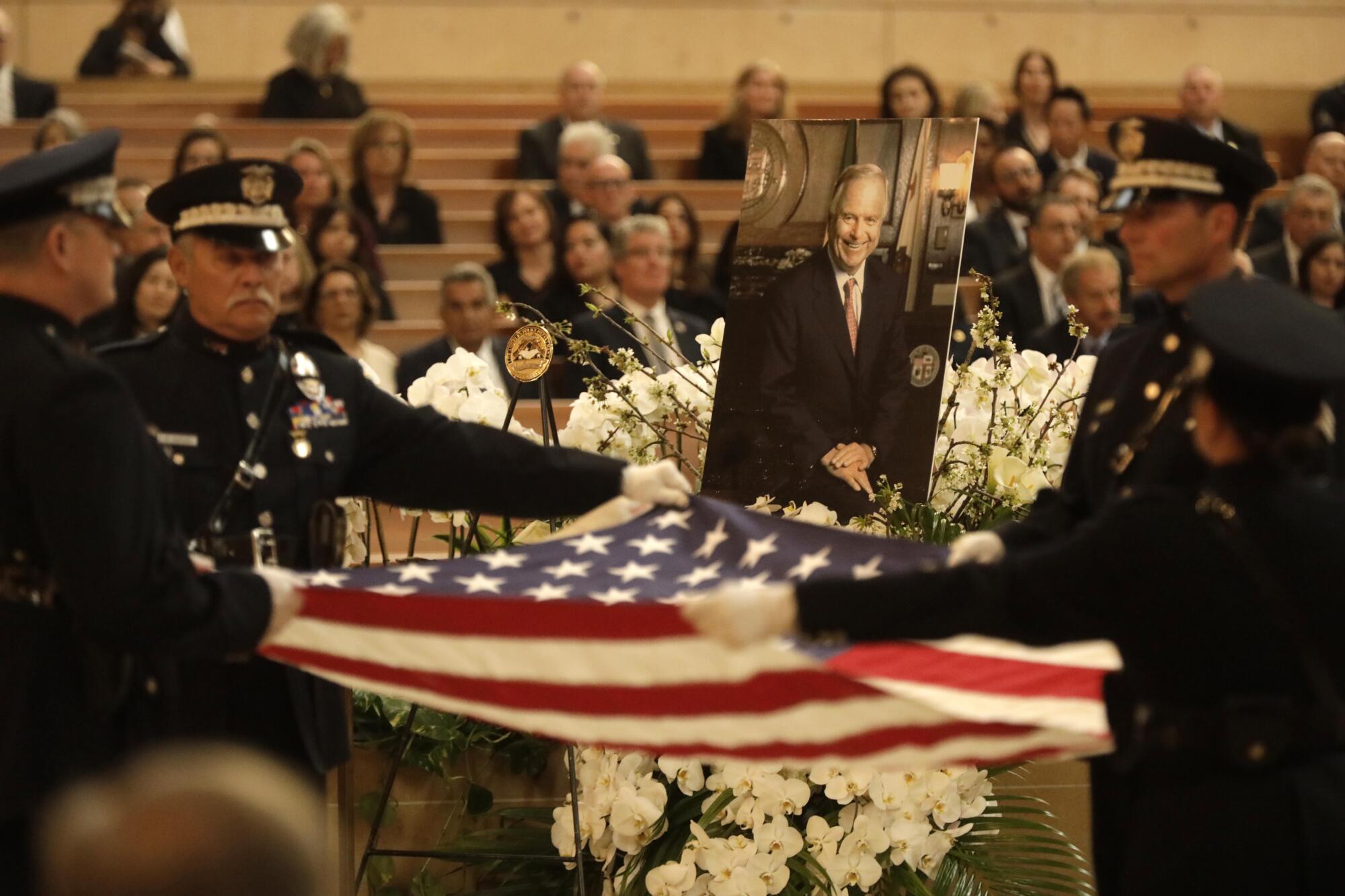 LAPD Color Guard present the flag, framed by a photo of former Los Angeles Mayor Richard Riordan