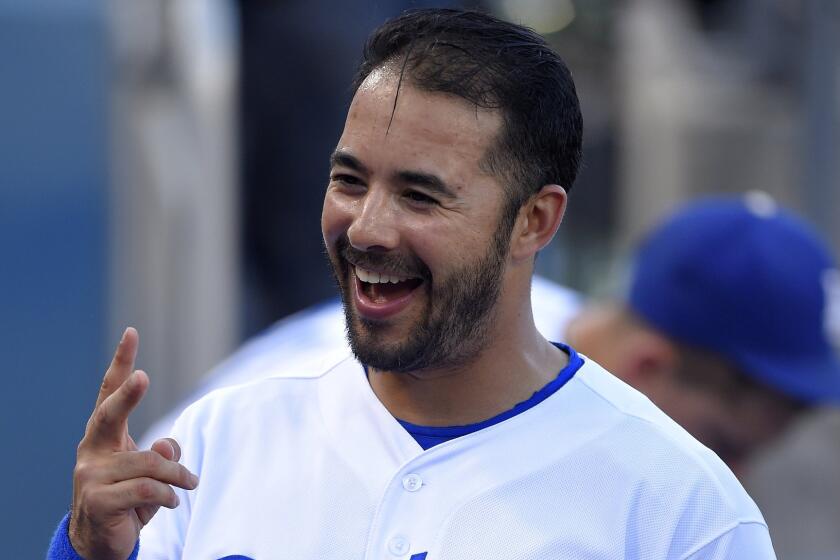 Dodgers left fielder Andre Ethier smiles while speaking to teammates in the dugout before Friday's loss to the visiting San Francisco Giants.