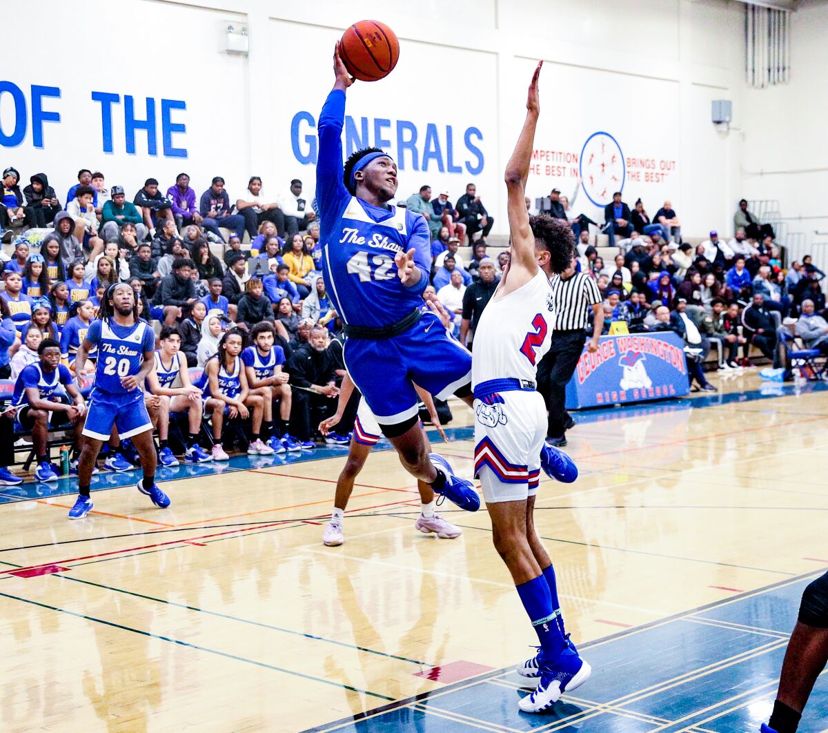 Crenshaw's AJ Robinson drives to basketball against Washington Prep's Devin Wilson.