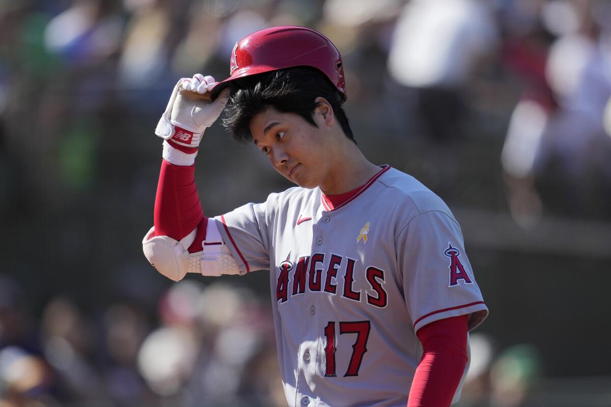Angels' Shohei Ohtani walks to the dugout after striking out against the Oakland Athletics on Sept. 3, 2023.