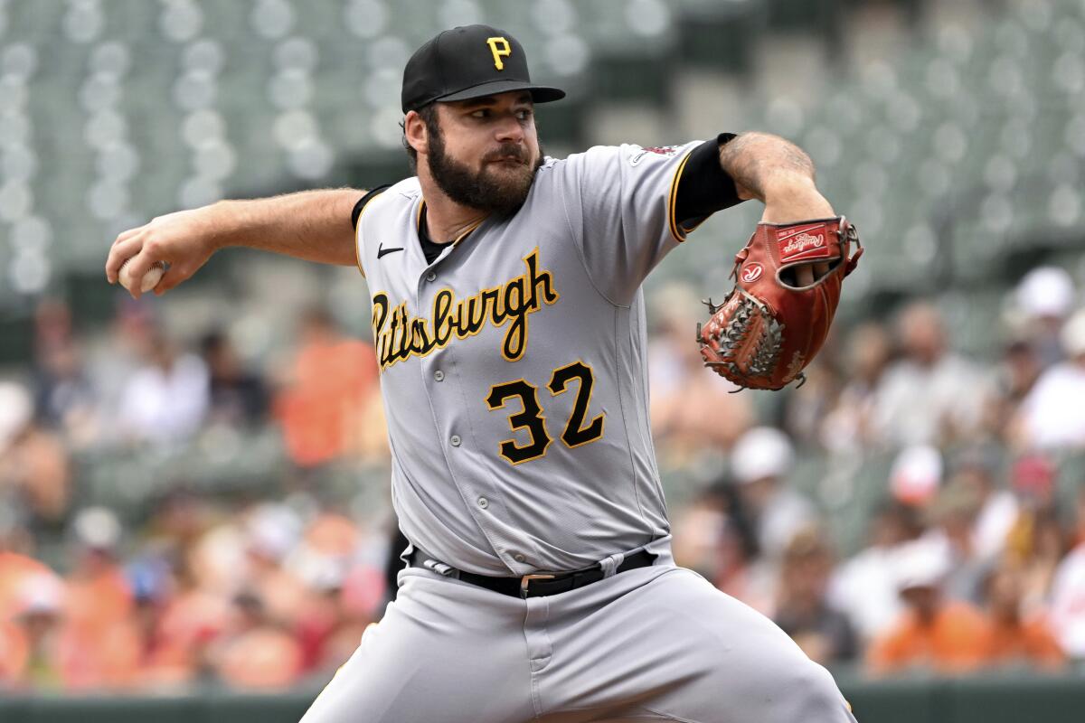 Pittsburgh Pirates starting pitcher Bryse Wilson (32) throws during the first inning of a baseball game against the Baltimore Orioles, Sunday, Aug. 7, 2022, in Baltimore. (AP Photo/Terrance Williams)