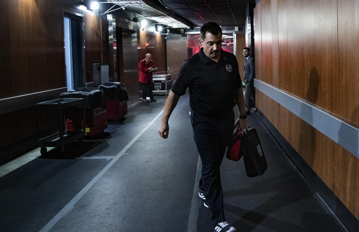 Kings trainer Chris Kingsley walks to the team bench from the locker room during warmups before a game against the Edmonton Oilers  at the Staples Center on Nov. 21.