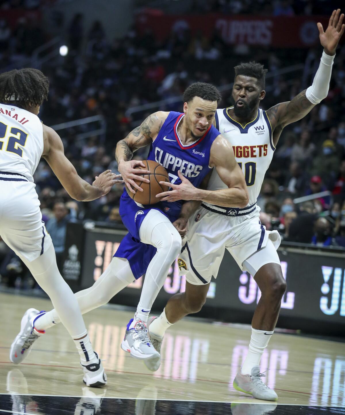 Clippers forward Amir Coffey drives down the lane against the Nuggets.