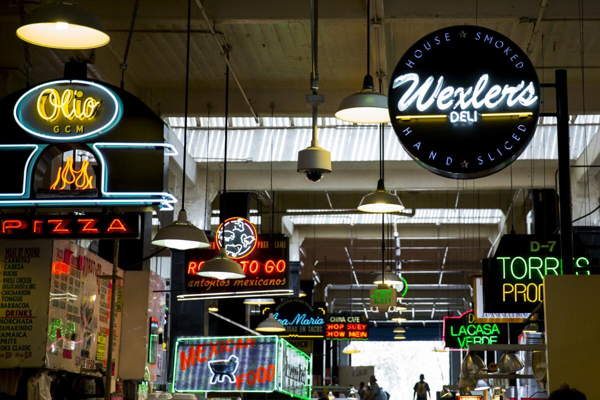 The neon signs inside Grand Central Market in downtown L.A., where St. Vincent's Meals on Wheels will be hosting an event to benefit the organization.