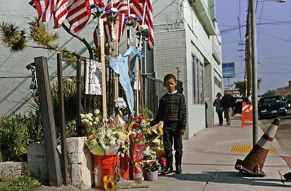 Rodney Bacchues, 6, laid flowers at the scene of the first shooting. Others expressed their condolences at City Hall, where community members could write messages in a notebook for each of the slain officers.