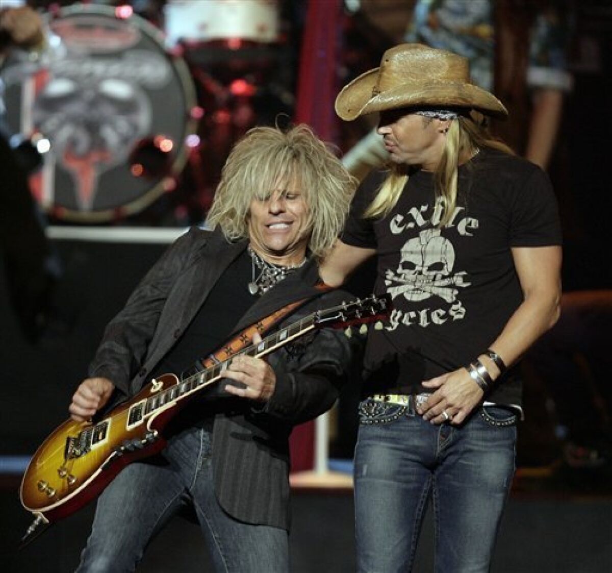 Bret Michaels, right, and C.C. DeVille of the band Poison perform 