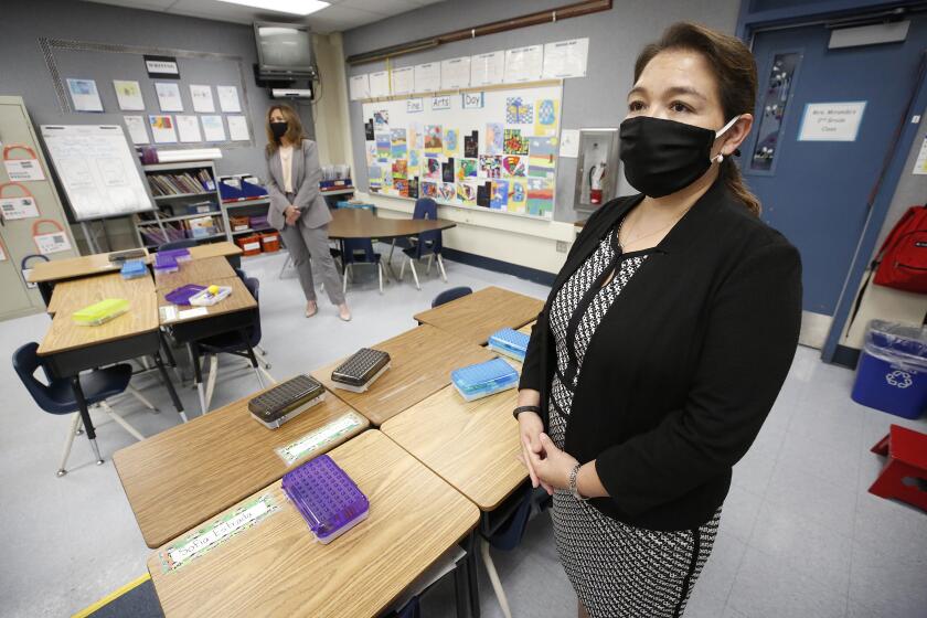 GLENDALE, CA - MAY 26: Los Angeles County Office of Education Supt. Debra Duardo, left, is given a tour Cerritos Elementary School in Glendale by Principal Perla Chavez-Fritz, right, on Tuesday May 26, 2020 considering that with a persisting coronavirus threat, K-12 campuses will try to reopen in the fall. New L.A. County guidelines offer a possible roadmap but it could get complicated and costly to confront the logistics of reopening at an actual school in the wake of Covid-19. Glendale on Tuesday, May 26, 2020 in Glendale, CA. (Al Seib / Los Angeles Times)