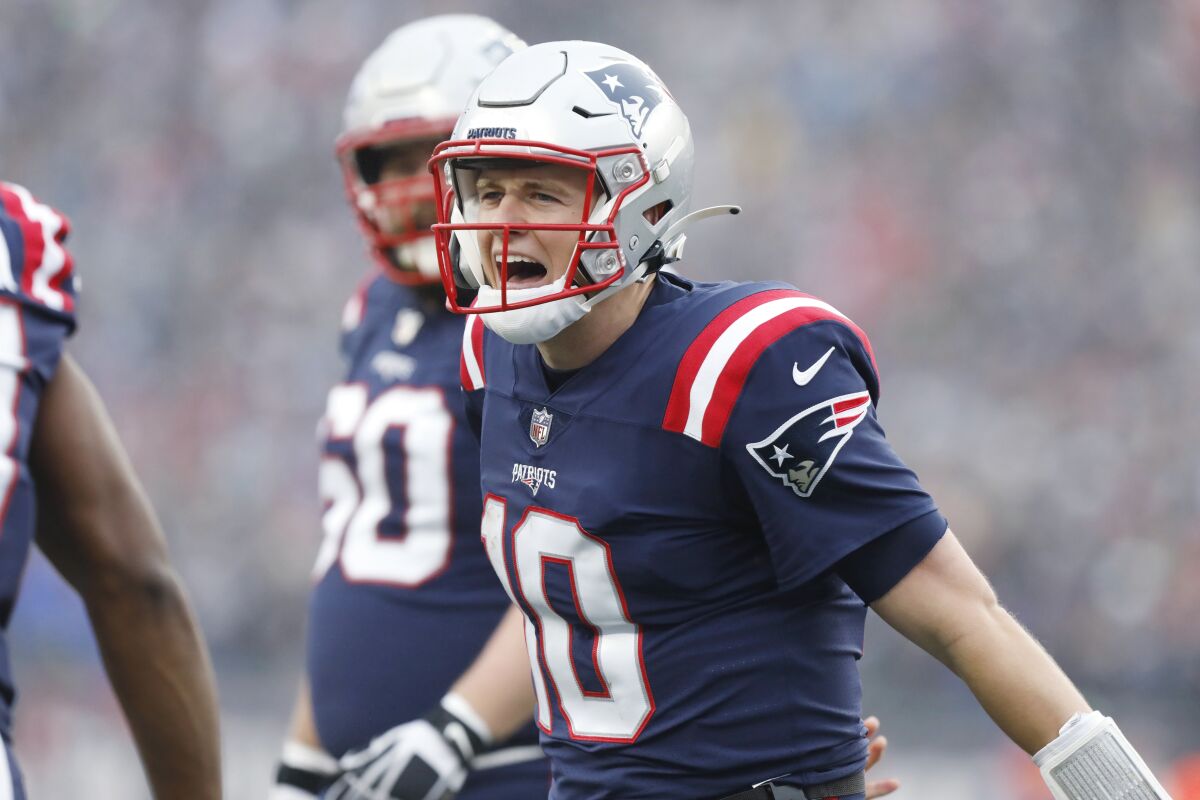 New England Patriots quarterback Mac Jones (10) celebrates after a touchdown pass to wide receiver Kristian Wilkerson during the first half of an NFL football game against the Jacksonville Jaguars, Sunday, Jan. 2, 2022, in Foxborough, Mass. (AP Photo/Paul Connors)