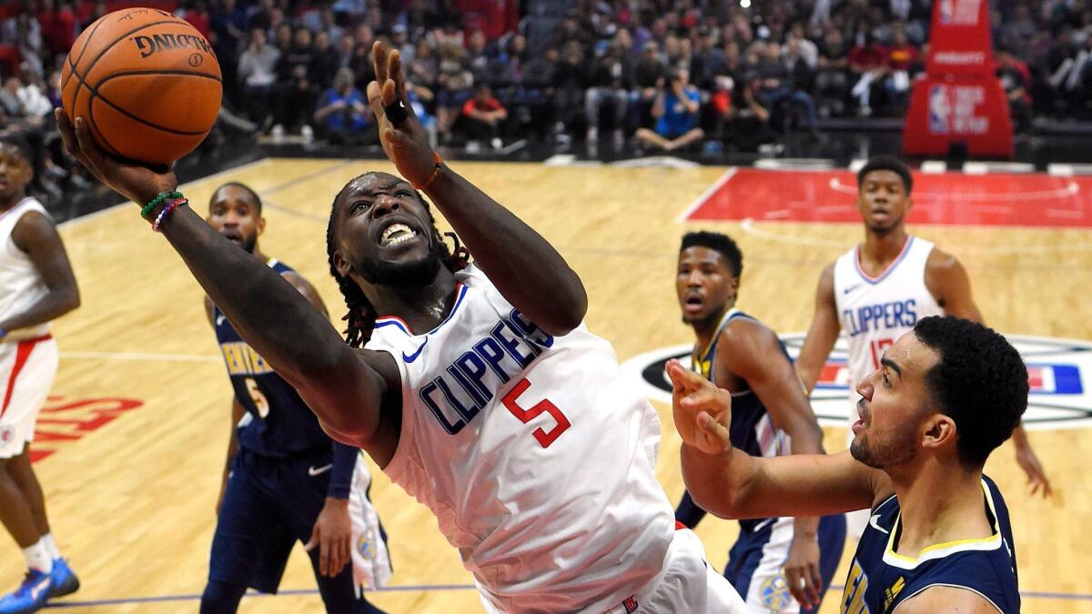 Clippers forward Montrezl Harrell shoots next to Denver's Trey Lyles on Jan. 17 at Staples Center.
