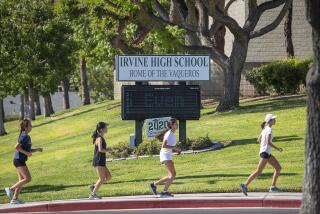 IRVINE, CA - SEPTEMBER 24: Irvine High School students run on campus on the first day of returning back to school since the coronavirus pandemic began at Irvine High School on Thursday, Sept. 24, 2020 in Irvine, CA. (Allen J. Schaben / Los Angeles Times)