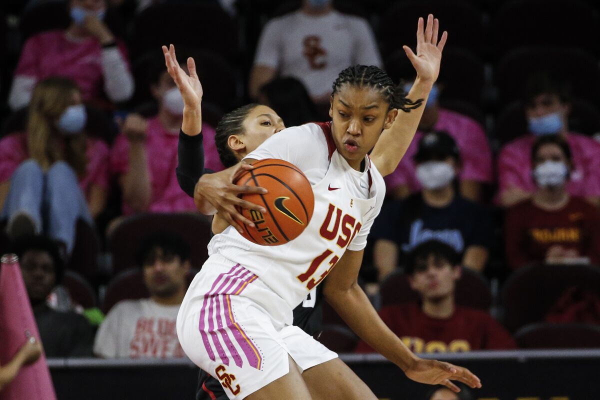 USC guard Rayah Marshall controls the ball in front of Stanford guard Anna Wilson.