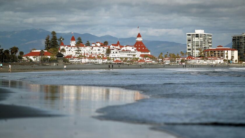 CORONADO_Dr. Beach, famous for judging the nation's top beaches will be coming out with his list later this week. Occasional favorite Coronado Beach may make the list .|The Hotel Del Coronado, seen at left in the background looms large over the beach at Coronado. At right in white are the Coronado Shores Towers.|John Gastaldo/San Diego Union-Tribune