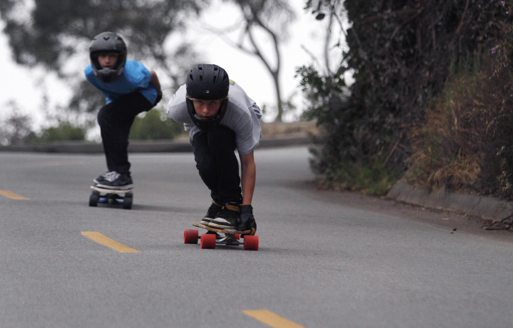 Two teens skate down Bluebird Canyon in Laguna Beach in 2010.