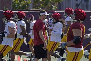 USC coach Lincoln Riley watches his team go through drills during spring football practice 
