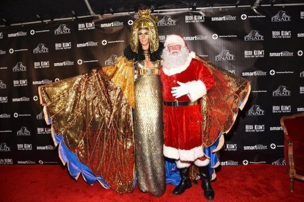 Supermodel Heidi Klum poses with Santa at her Halloween party in December.