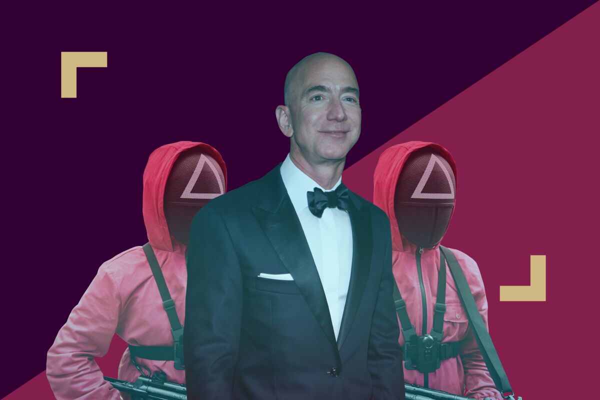 Jeff Bezos among two costumed people. 