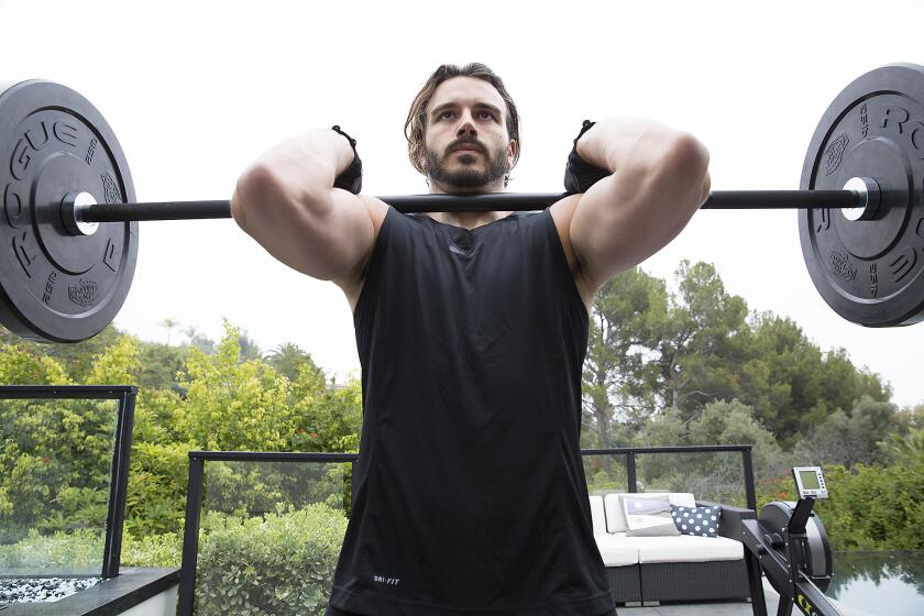 Producer Charlie Ebersol works out in the backyard of his Beverly Hills home.