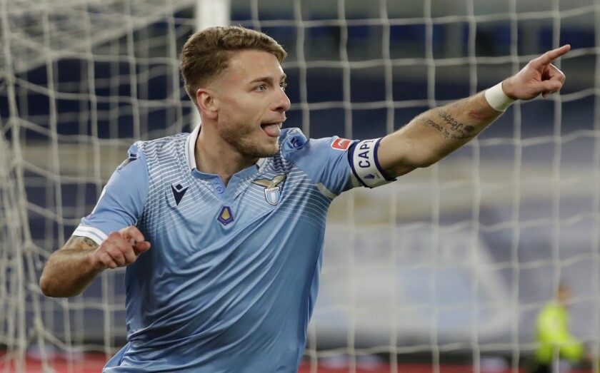 Lazio's Ciro Immobile celebrates after scoring his sides first goal during the Serie A soccer match between Lazio and Roma, at Rome's Olympic Stadium, Friday, Jan. 15, 2021. (AP Photo/Andrew Medichini)