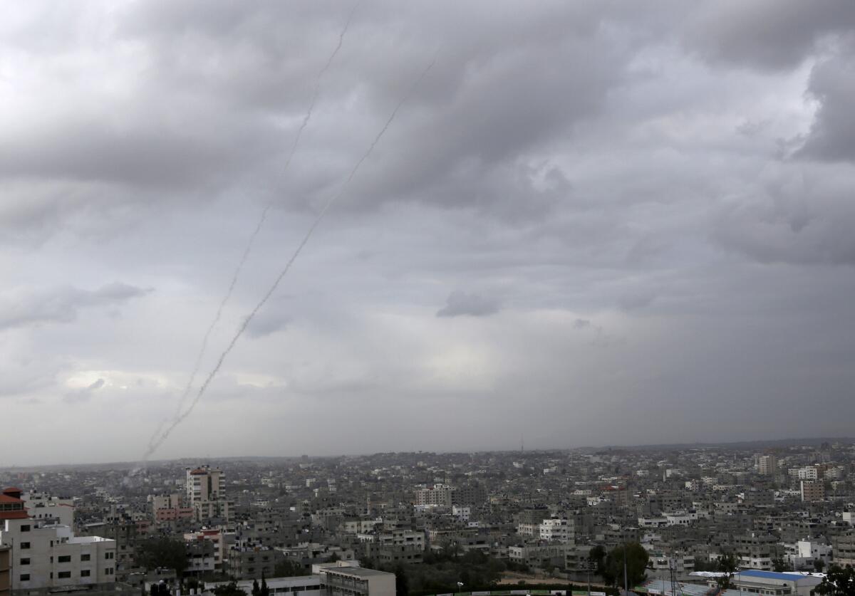 Trails of smoke from rockets fired from the Gaza Strip toward Israel are seen above Gaza City. Israel responded with artillery fire and airstrikes.