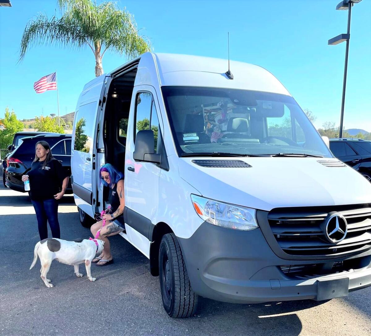 Dog detective Babs Fry, l, stands by her Mercedes Sprinter purchased with the help of donations to replace her wrecked van.