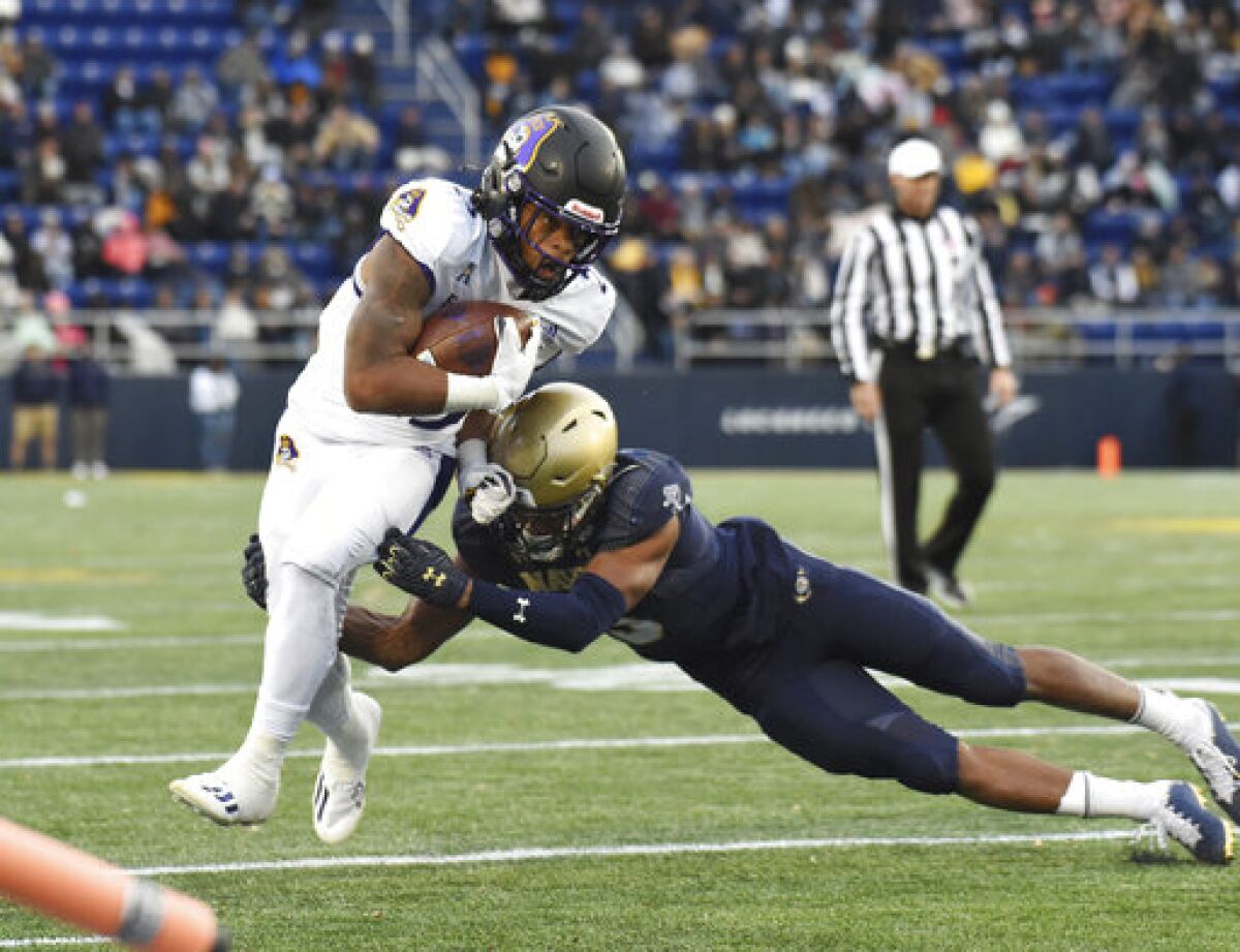 East Carolina running back Keaton Mitchell is forced out of bounds by Navy's Michael McMorris during the second quarter of an NCAA college football game Saturday, Nov. 20, 2021, in Annapolis, Md. (Paul W. Gillespie/The Baltimore Sun via AP)
