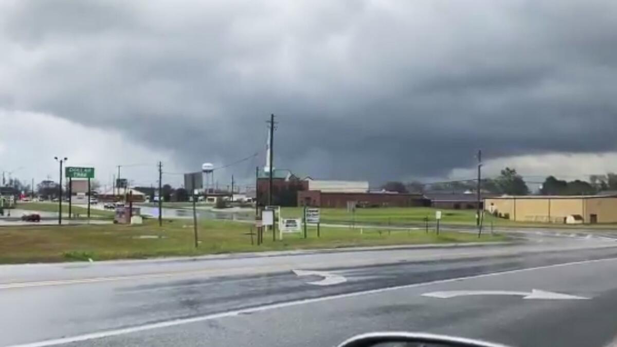 A funnel cloud hovers in Byron, Ga. The National Weather Service on Sunday issued a series of tornado warnings stretching from Phenix City, Ala., to Macon, Ga., about 100 miles to the east.