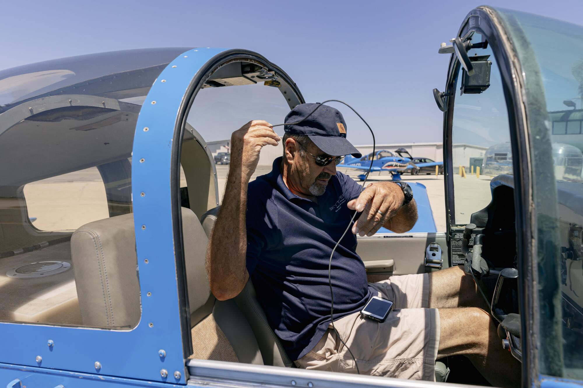 Skytypers pilot John Renquist sits in the airplane cockpit