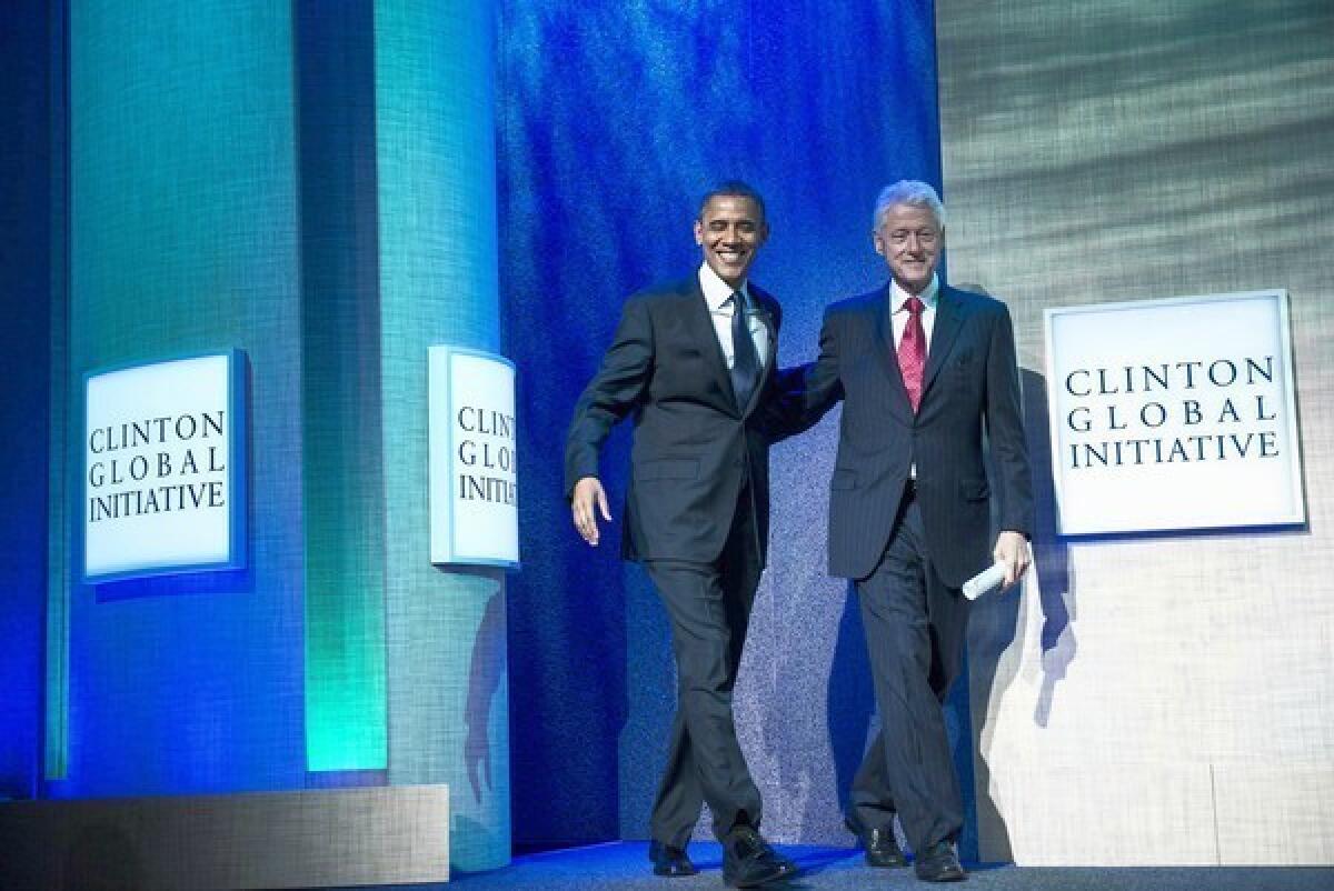 President Obama and former President Clinton arrive on stage at the Clinton Global Initiative annual meeting in New York. Obama's address focused on human trafficking.