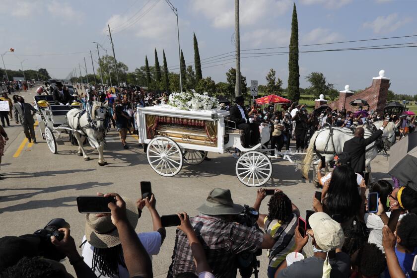 George Floyd's funeral procession arrives at Houston Memorial Gardens cemetery, Tuesday, June 9, 2020, in Pearland, Texas. (AP Photo/Eric Gay)