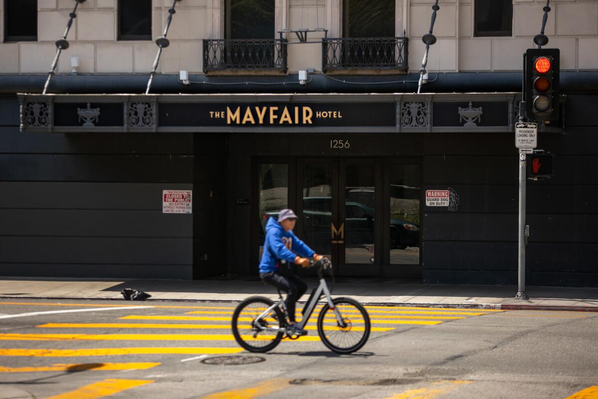 A man bicycles past the Mayfair Hotel.