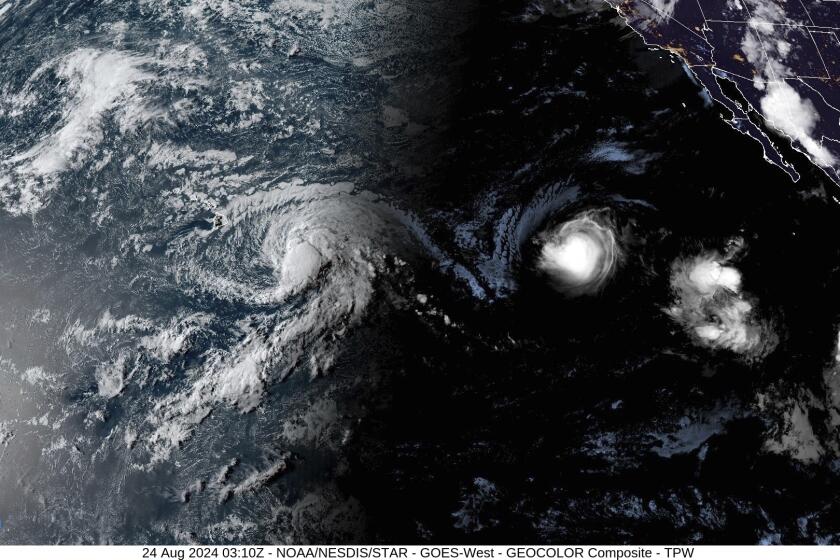 This satellite image provided by the National Oceanic and Atmospheric Administration (NOAA) shows Tropical Storm Hone and Hurricane Gilma located southeast of Hawaii, Friday, Aug. 22, 2024. (NOAA via AP)