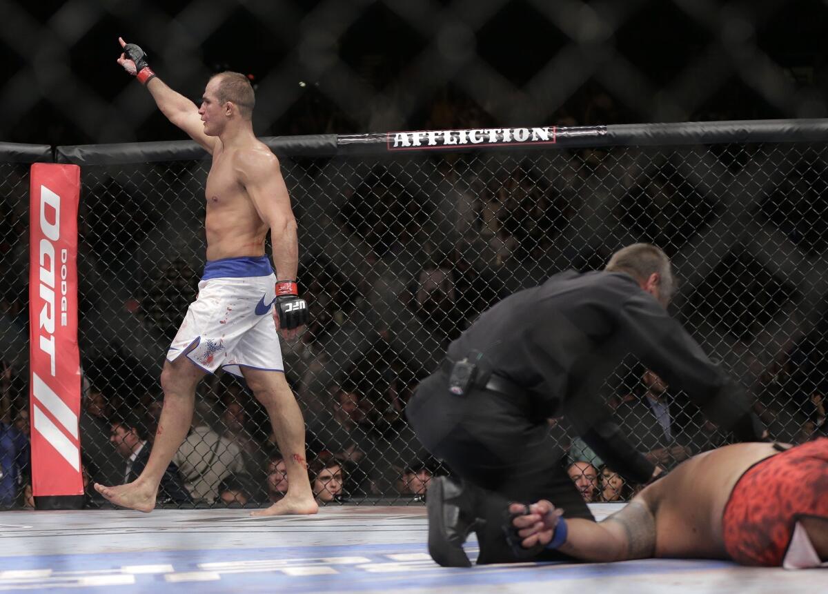 UFC heavyweight Junior Dos Santos waves to the crowd after knocking out Mark Hunt in the third round Saturday night.