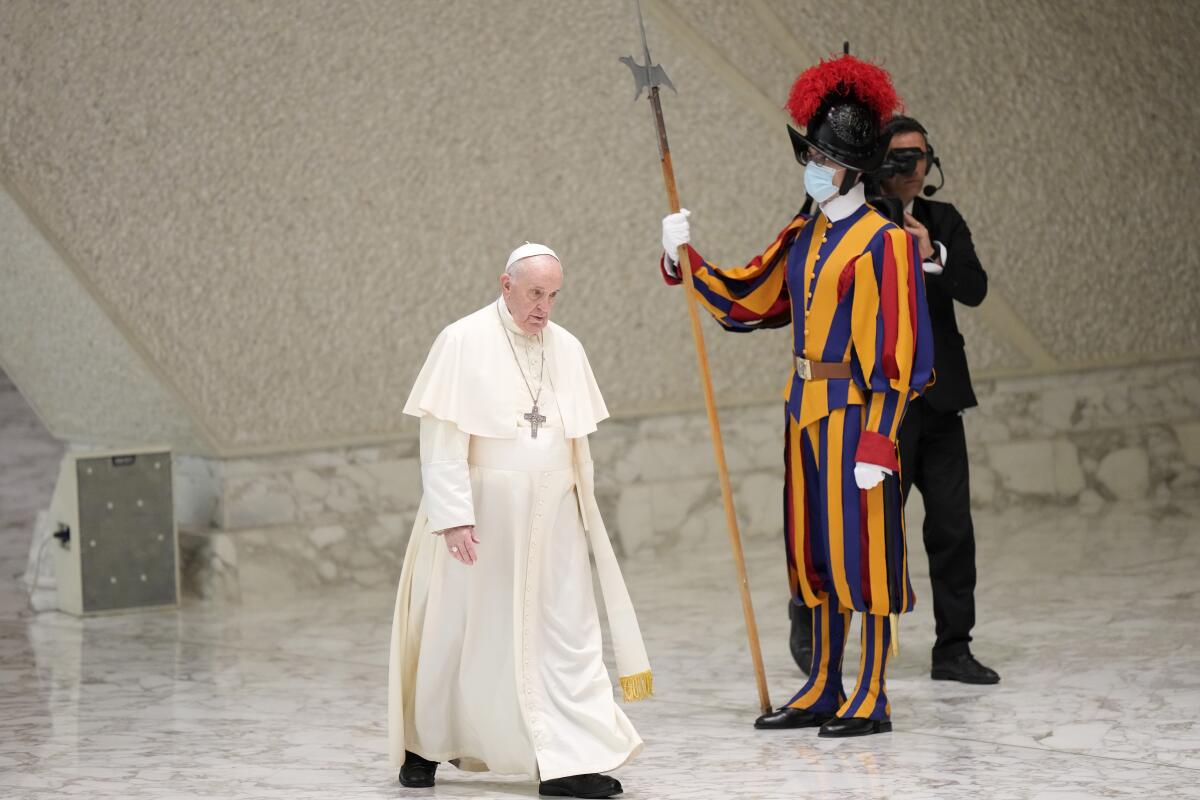Pope Francis walks past a Vatican Swiss Guard as he arrives for his weekly general audience in the Paul VI hall, at the Vatican, Wednesday, Sept. 8, 2021. (AP Photo/Andrew Medichini)
