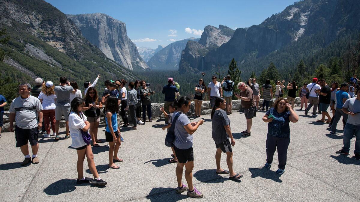 Visitors crowd Yosemite's Tunnel View overlook. (Brian van der Brug / Los Angeles Times)