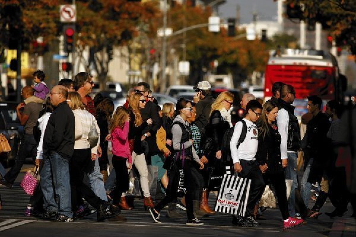 Shoppers brave the Third Street Promenade crowds on Super Saturday in Santa Monica.
