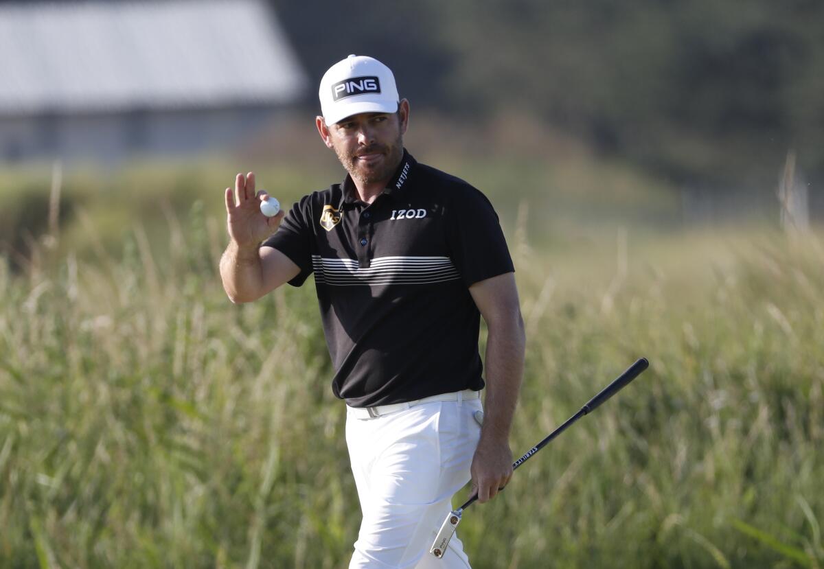 Louis Oosthuizen acknowledges the crowd after making an eagle on No. 14 during the second round of the British Open.