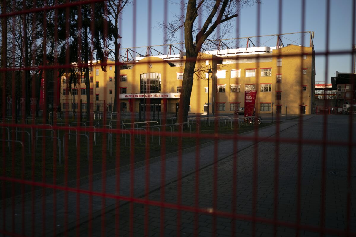 Gates are closed at the stadium 'An der alte Foersterei' where the German Bundesliga soccer match 1. FC Union Berlin against FC Bayern should have taken place in Berlin, Germany, Saturday, March 14, 2020. After the other four main leagues in Europe had already been suspended, the German soccer authorities gave in and suspended all Bundesliga games because of the novel coronavirus outbreak on Friday. For some, especially older adults and people with existing health problems, it can cause more severe illness, including pneumonia.(AP Photo/Markus Schreiber)