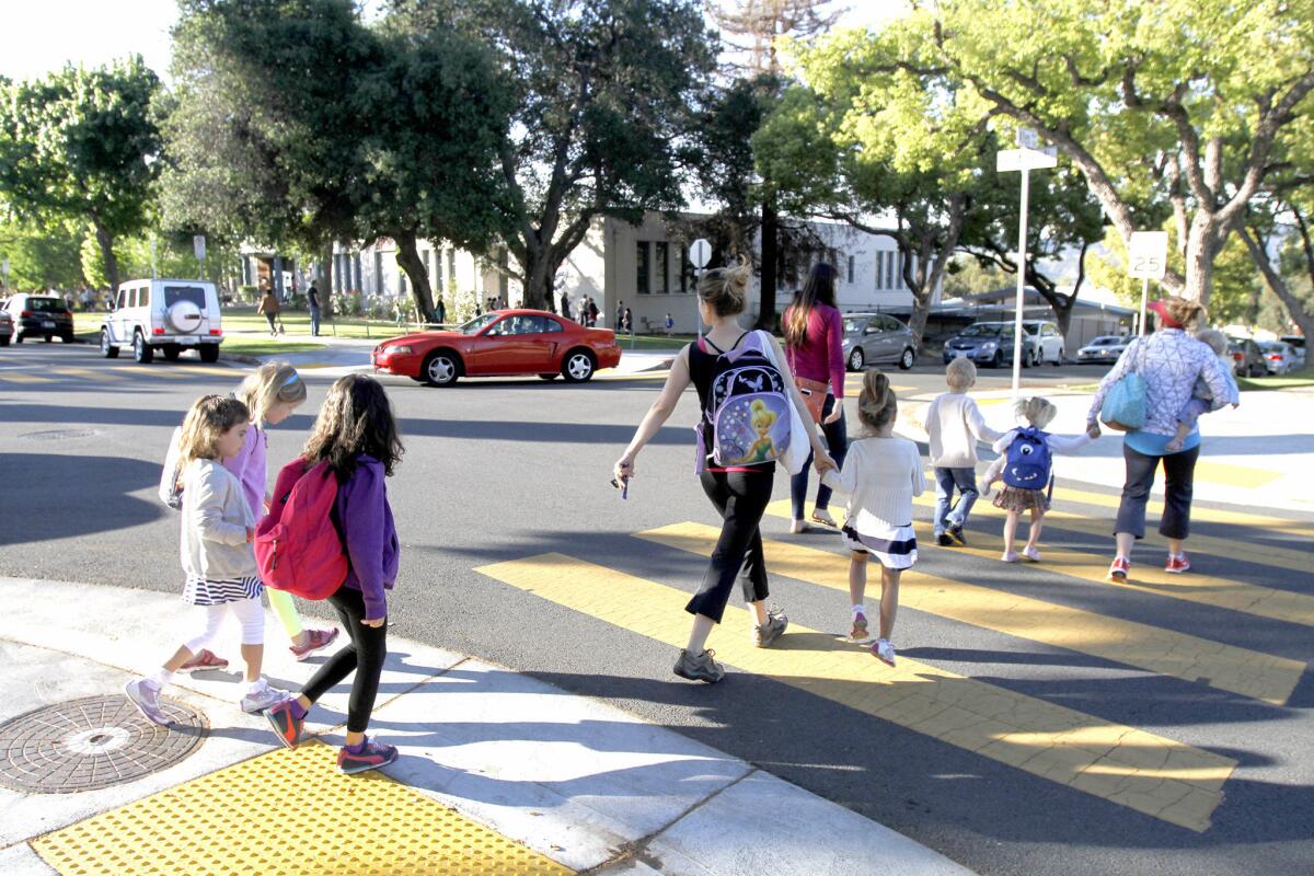 A group of parents and children cross at Allen Ave. and Bel Aire Dr. in front of Balboa Elementary School in Glendale on Thursday, April 10, 2014.