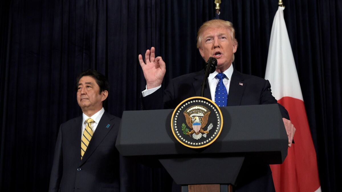 President Donald Trump speaks as Japanese Prime Minister Shinzo Abe listens at Mar-a-Lago in Palm Beach, Fla. on Feb. 11.