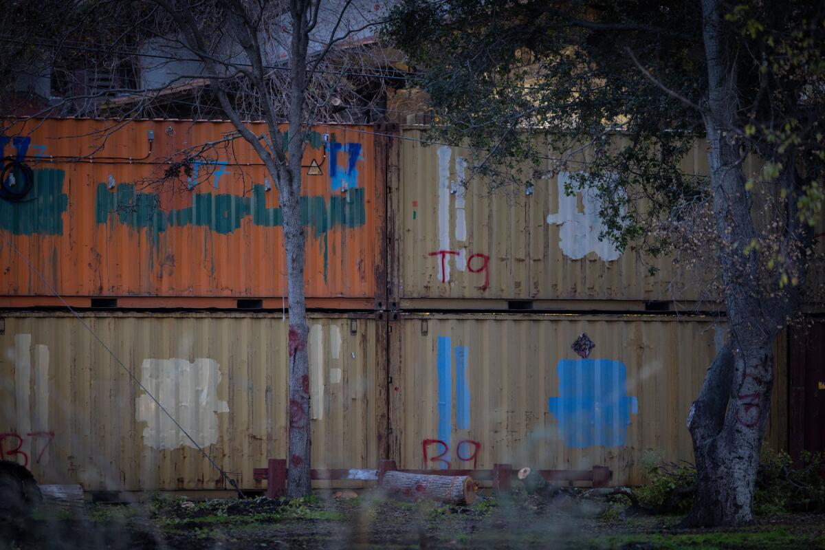 Cargo containers form a barrier around a park. 