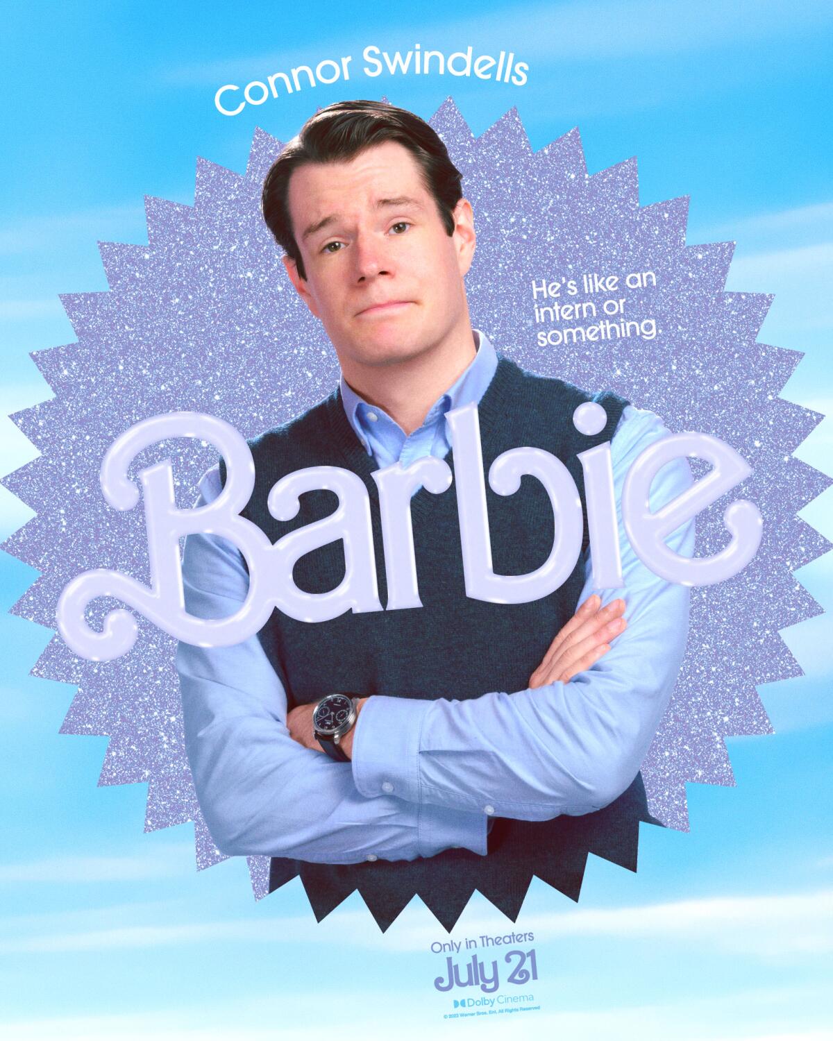 Connor Swindells poses with his arms crossed in a "Barbie" movie poster. He wears a blue shirt and sweater vest